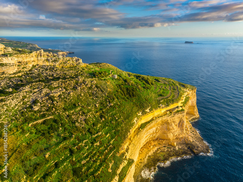 Drone view of cliffs and sea. Sunset, countryside, rocks, hills. Mediterranean sea, Malta island