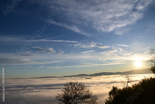 Stunning sunrise from a mountain top over the clouds