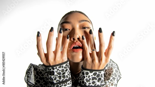 Fashion model posing with hands in slow motion on white background