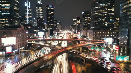 Nighttime Cityscape - Captivating View of Urban Architecture and Busy Roads.