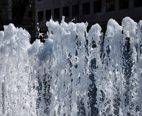 Frozen motion of dancing water flows in fountain with blurred background. Budapest, Hungary