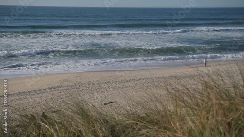 Walking Along the Portugal Shore at a Beach During the Day With Ocean Waves Rolling In