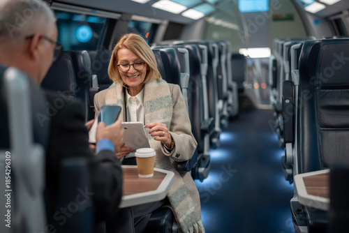 Fotografía Mature businesswoman using digital tablet on a modern train
