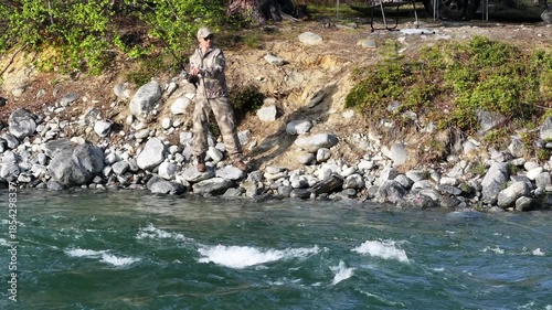 Fishing at a Riverbank in Nature During the Afternoon Hours