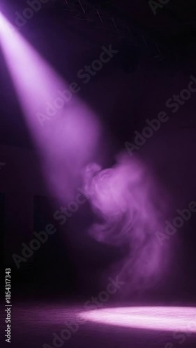 Dramatic Purple Spotlight Beam Illuminating Smoke on Dark Stage.