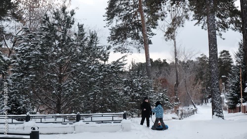 Active happy children enjoying wintertime, holidays. Happy winter time, vacations, healthy activity, toboggan, tubing. The children take pleasure in playing outside. Ski holiday. Real authentic life