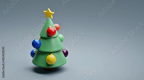 Colorful miniature Christmas tree with star and ornaments on gray background
