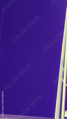 Neon Christmas tree lights against purple sky