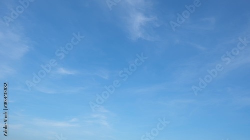 A calming blue sky timelapse video featuring soft, wispy clouds drifting gently across a clear atmosphere, symbolizing tranquility, freedom, and the natural beauty of ever-changing cloud formations.
