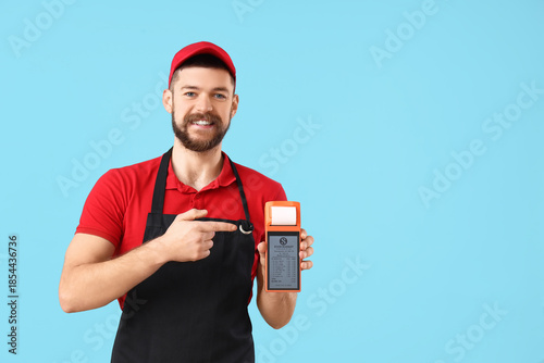 Male cashier pointing at pa...
