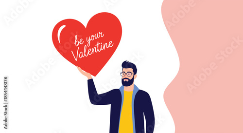 Stylish bearded man with glasses holding up a large red heart with the message 'be your Valentine,' perfect for Valentine's Day cards.