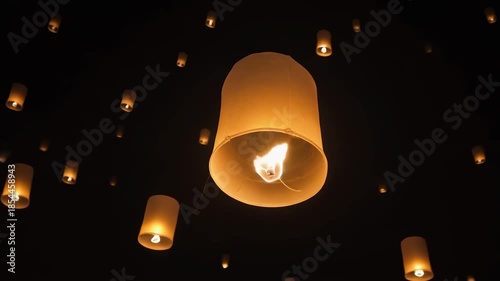Floating lanterns illuminating the night sky during a festival celebration