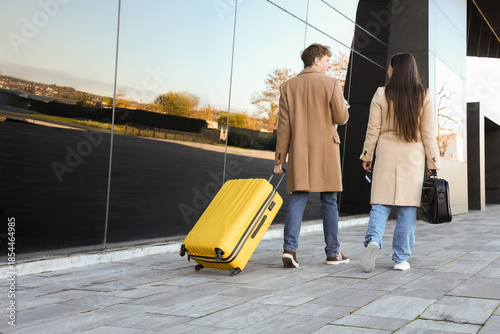 Young couple with luggage w...