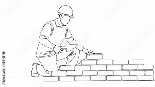 Construction worker building a brick wall with trowel and bricks.