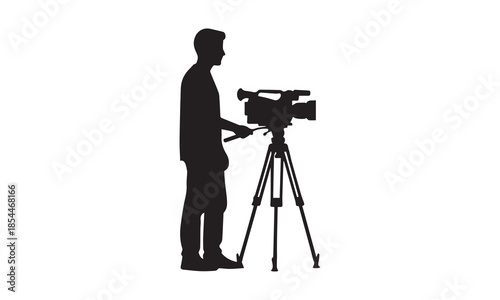 Professional cameraman silhouette operating a video camera on a tripod for film production