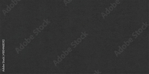 A dark and rough black leather fabric texture features a macro closeup of the vintage material surface, creating a detailed textile pattern backdrop for a gray cloth canvas or design wallpaper