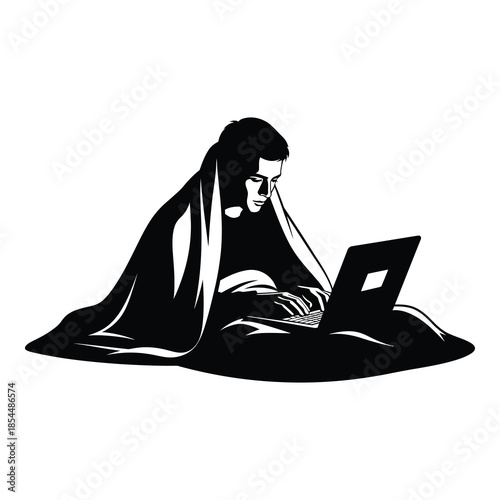 Focused young man working intently on a portable computer while snugly covered in a large blanket on white background. on white background