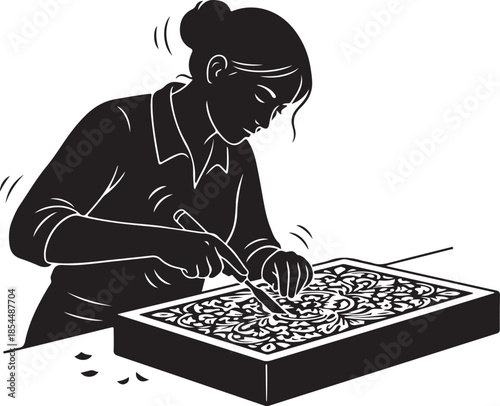 Woman engraving intricate patterns on a woodcut block, showcasing the art of traditional hand carving and creative craftsmanship.
