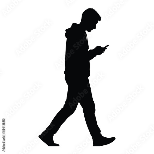Silhouette of a young man wearing a hooded sweatshirt walking while intently looking down at his mobile smartphone on white background