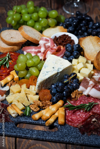 assorted cheeses, fruits and meats, vertical