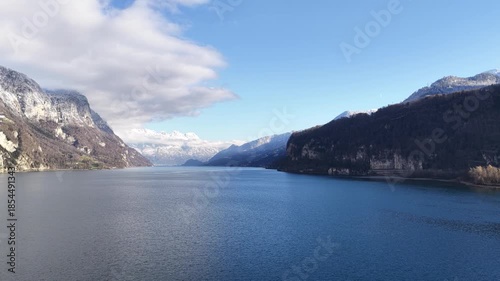 Wallpaper Mural Walensee Switzerland drone push forward over calm blue lake surrounded by alpine mountains, winter landscape, clear sky and peaceful European nature. Torontodigital.ca