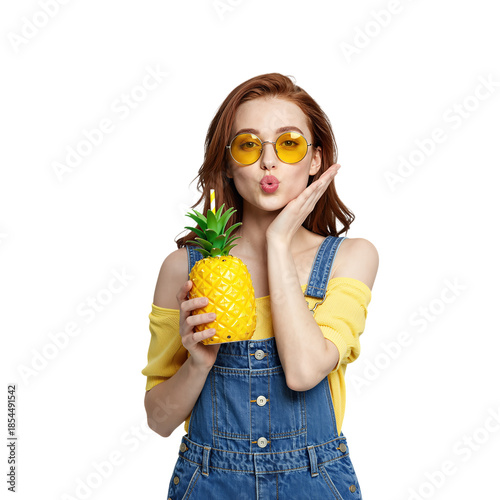 Young woman with yellow sunglasses holding a pineapple drink