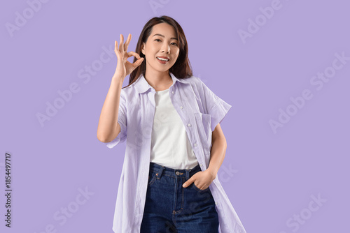 Young Asian woman showing O...