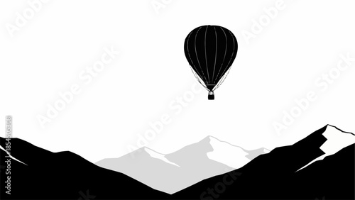 Black hot air balloon floating above snow capped mountains.