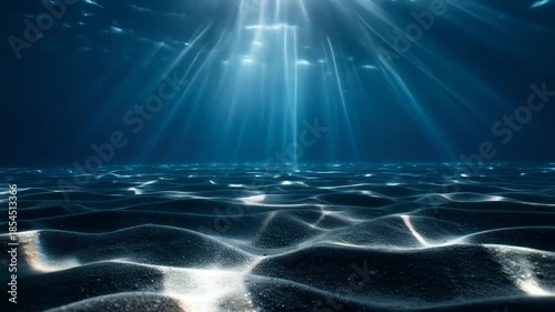 Sunlight streams through the ocean's surface, illuminating the sandy seabed with ethereal light and shadows.