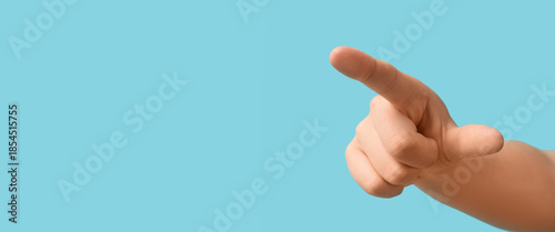 Male hand pointing at viewer on blue background, closeup