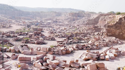 industrial mining site with extracted stone slabs in Aravalli mountain range at day