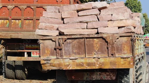 heavy sandstone slabs stacked on old truck for construction transport