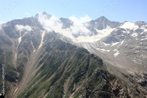 Panoramic view of majestic mountain range with snowy peaks