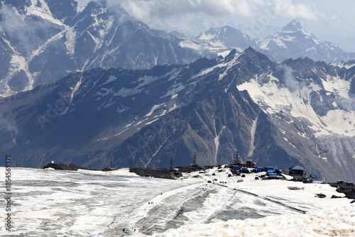 Panoramic view of snowy elbrus slopes with buildings and cable car stations
