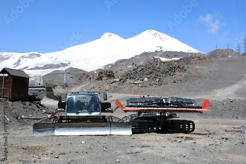 Snowcat and PistenBully machine on volcanic terrain near Mount Elbrus