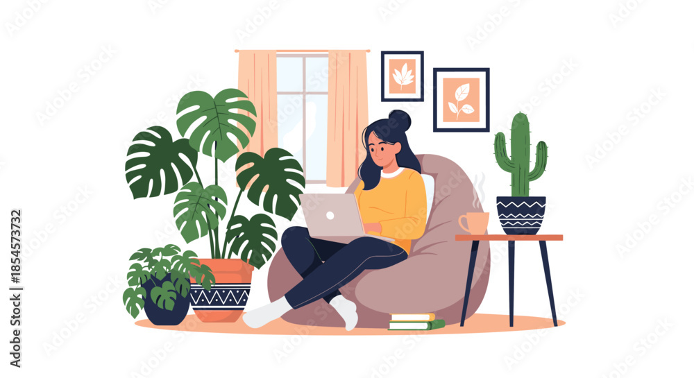 Fototapeta premium Creative woman works comfortably on her laptop while sitting in a large bean bag chair surrounded by lush green houseplants.