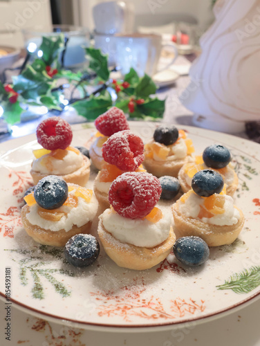Dessert with powdered sugar, berries in shortcrust pastry baskets. Homemade healthy food. Holidays and desserts.