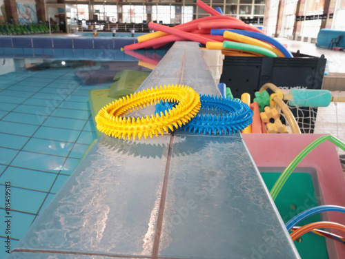 Swimming pool with swimming equipment. Sports for children and adults. Design backdrop. Health and lifestyle.