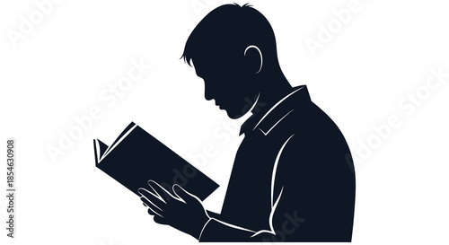 A focused man intently reading a book captured in a striking dark silhouette