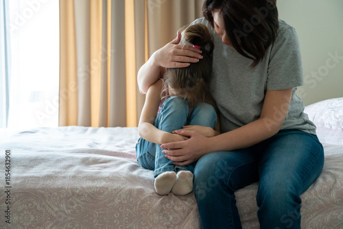 Fotografija Loving young mother touching upset little daughter, expressing support, young mu