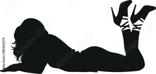 Black silhouette of a glamorous woman lying on her stomach with legs raised in the air wearing high heel stilettos.