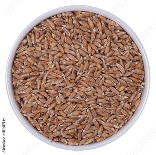 Schilderij op canvas Isolated bowl with spelt groats on a white background, top view