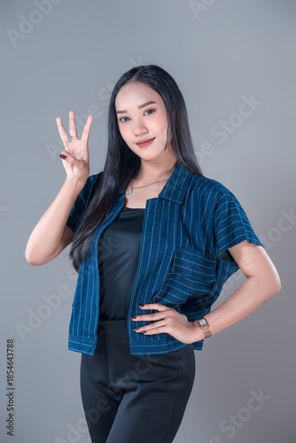 Indonesian Woman Showing Three-Finger Gesture with Confident Smile