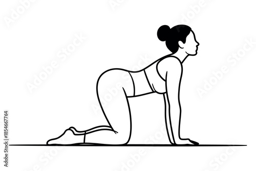 A woman performs the cat pose in yoga on a yoga mat, illustrating spinal flexibility and mindfulness.