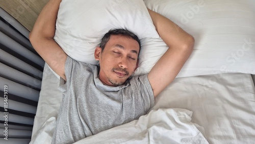 Asian man in bed