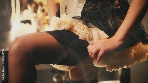 art video close-up hand happy retro lady puts on stockings on legs, short beauty dress. silhouette body part sexy woman cropped face burlesque show dancer. flapper girl 20s roaring twenties old style.