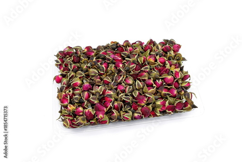 Dried Rose Buds. Dried red or pink rose buds. Natural dried rose tea isolated on white background  