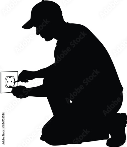 Black silhouette of an electrician kneeling and repairing a power outlet isolated on white background, electrical maintenance and service vector.