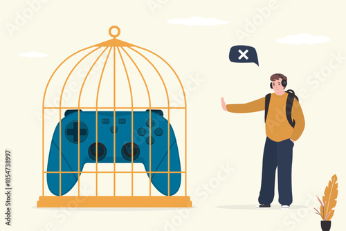 No gaming. Game joystick closed in birdcage. Quit games. Stop play video games. Happy player man refuse gaming, young adult show stop gesture.