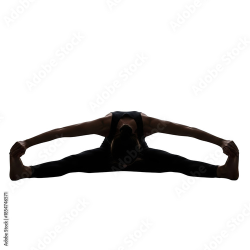 Woman in silhouette performing wide-legged forward bend yoga pose